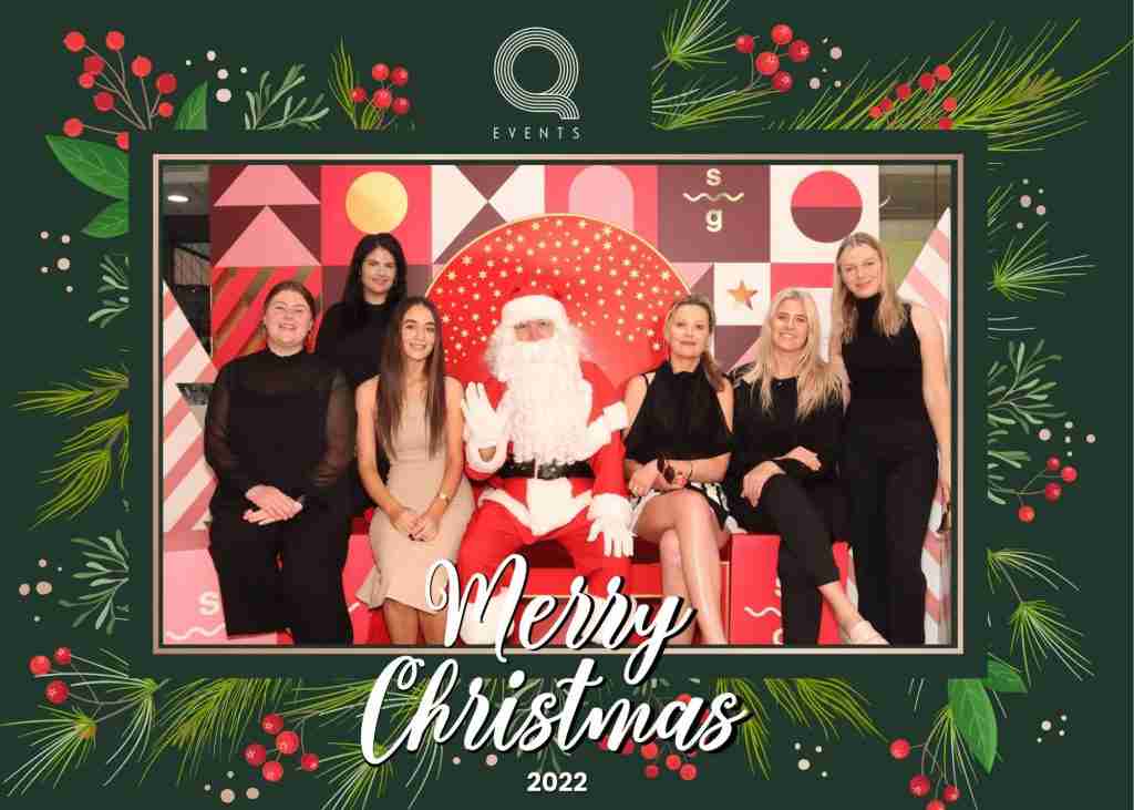 q events staff photo with santa