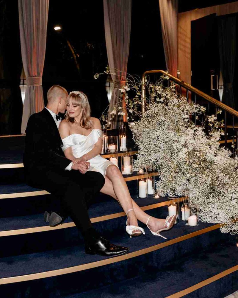 bride and groom sitting down at q events wedding venue melbourne